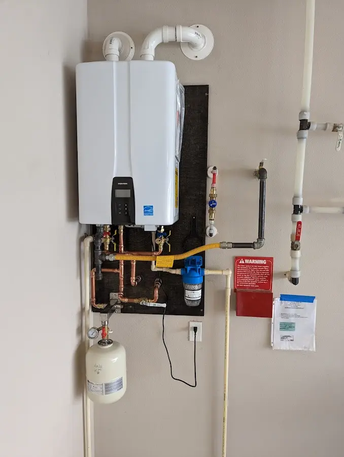 Professional plumber installing copper piping in a Morris home